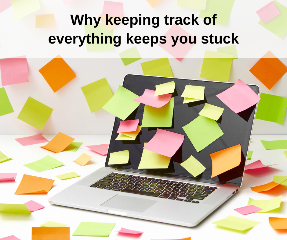 picture of a laptop, surface, and wall covered in colorful sticky notes with text on top saying, "Why keeping track of everything keeps you stuck"
